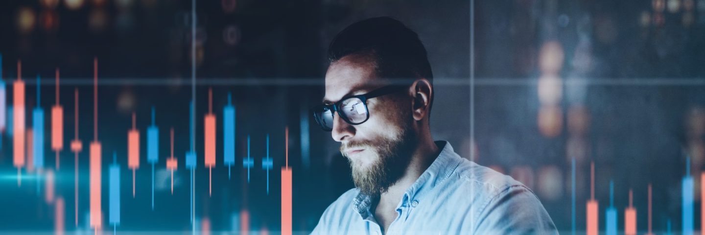 Double exposure.Market traider making analysis of digital market and investment in block chain crypto currency. Red and green candlestick chart and stock trading computer screen background.