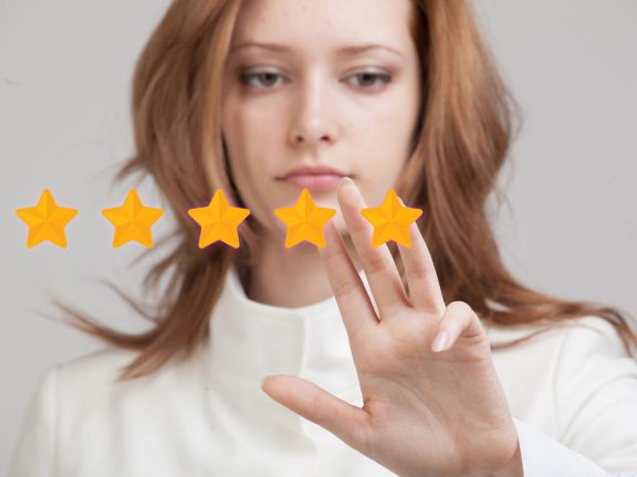 Five star rating or ranking, benchmarking concept. Woman assesses service, hotel, restaurant