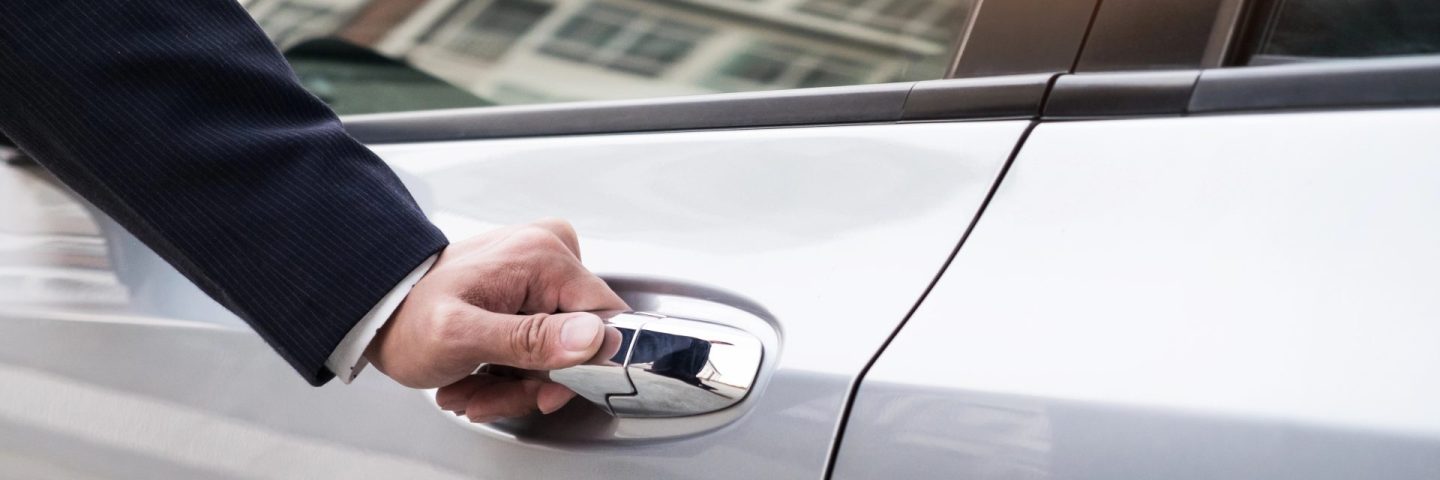 man in formal wear opening car door