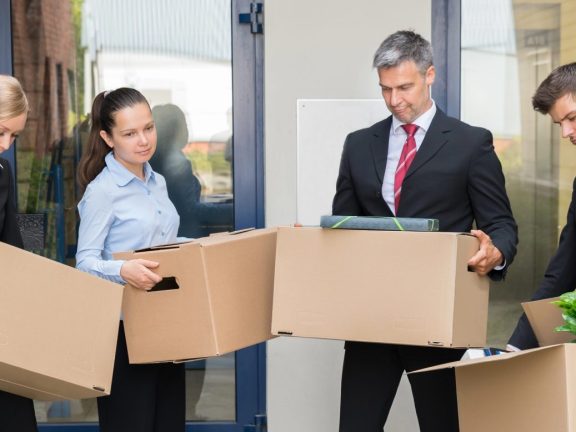 Unhappy Businesspeople With Cardboard Boxes Outside