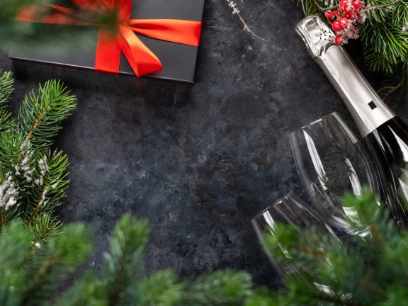 Christmas gift boxes and champagne. Flat lay with space for your Xmas greetings