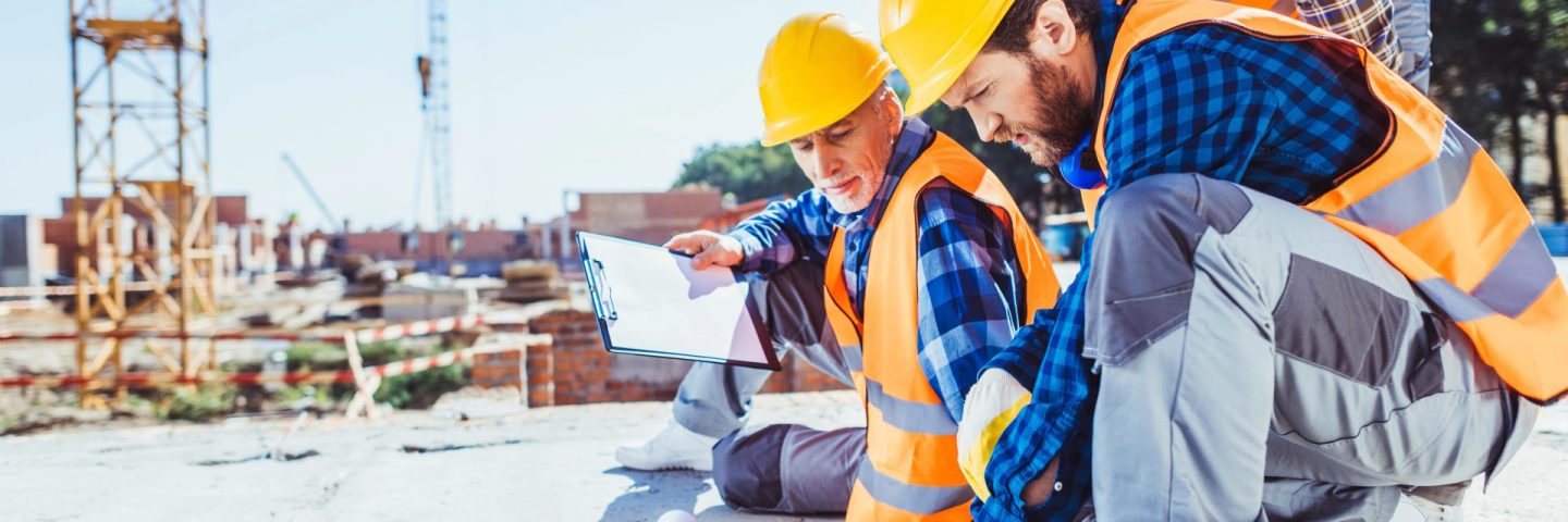 construction workers looking at building plans