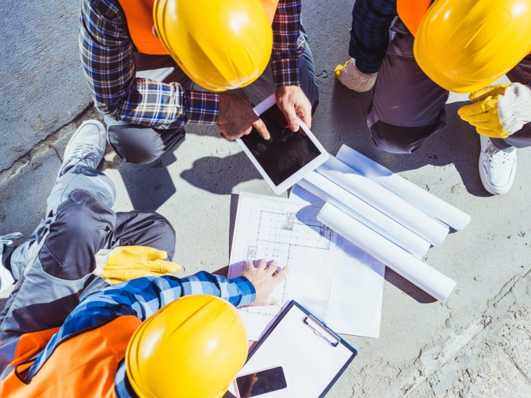 construction workers discussing building plans