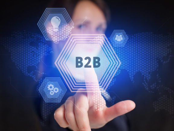 Business, Technology, Internet and network concept. Young businessman working on a virtual screen of the future and sees the inscription: B2B