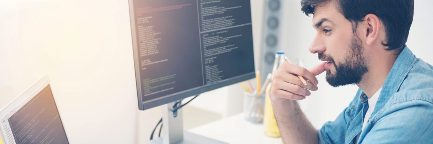 Young programmer coding in an office