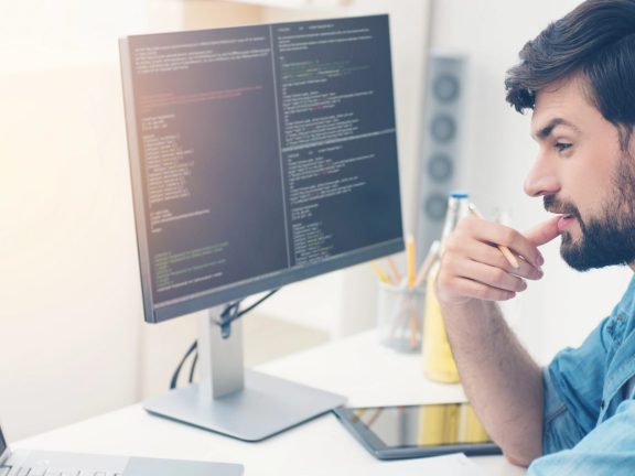 Young programmer coding in an office