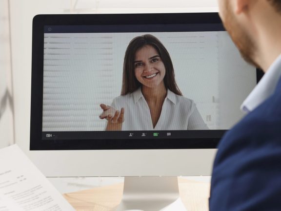 Human resources manager conducting online job interview via video chat on computer, closeup