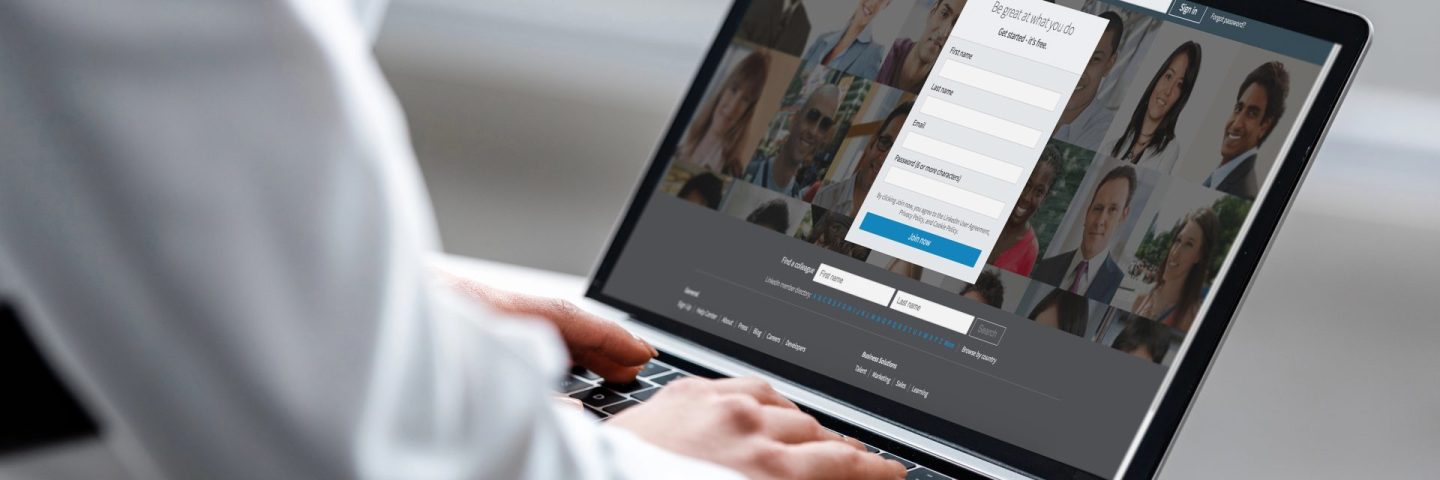 cropped view of woman using laptop with linkedin website on screen