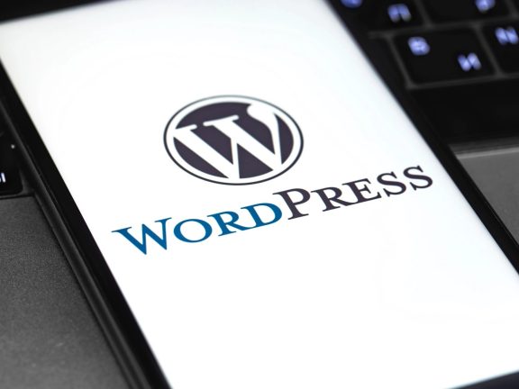 WordPress logo on the display smartphone and notebook closeup. WordPress - open source site content management system. Moscow, Russia - June 24, 2020