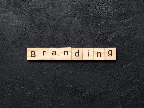 branding word written on wood block. branding text on table, concept.