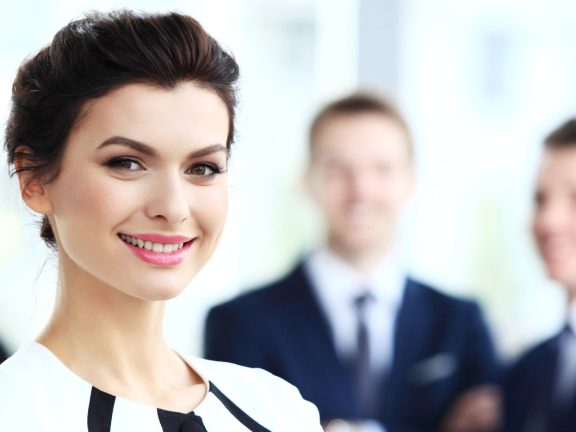 Face of beautiful woman on the background of business people