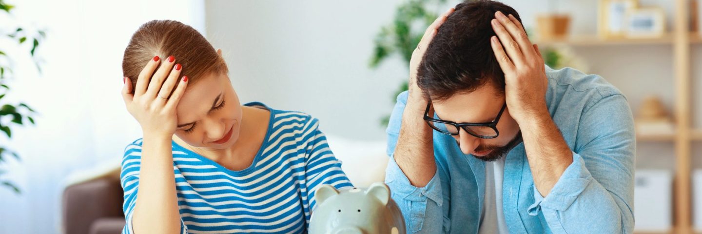 financial planning bankrupt family couple in stress with piggy