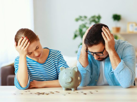 financial planning  bankrupt family couple in stress with piggy