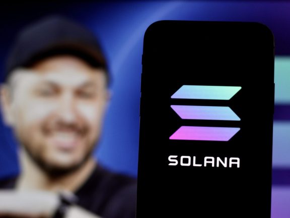 In this Photo Solana Cryptocurrency logo is displayed on a smartphone screen With CEO Anatoly Yakovenko in the background.indonesia-may 17th 2024.