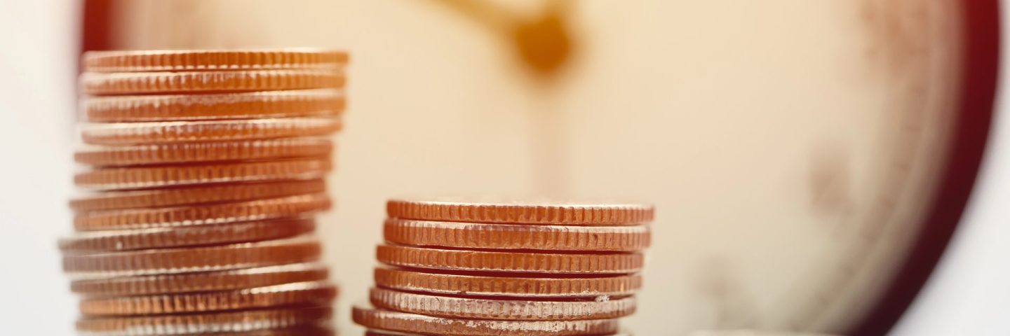 Money with the clock. Business Times wealth income concept.