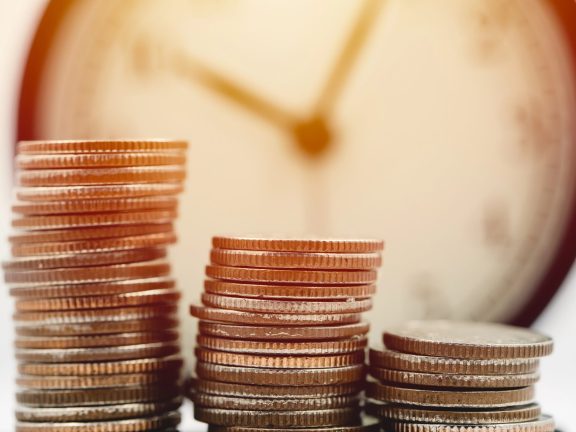Money with the clock. Business Times wealth income concept.