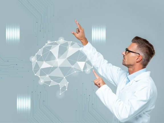side view of handsome scientist in glasses moving brain interface isolated on grey, artificial intelligence concept
