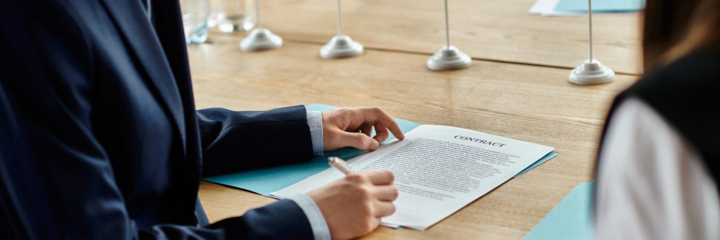 Two teenagers participate in a UN Model conference, signing a contract.