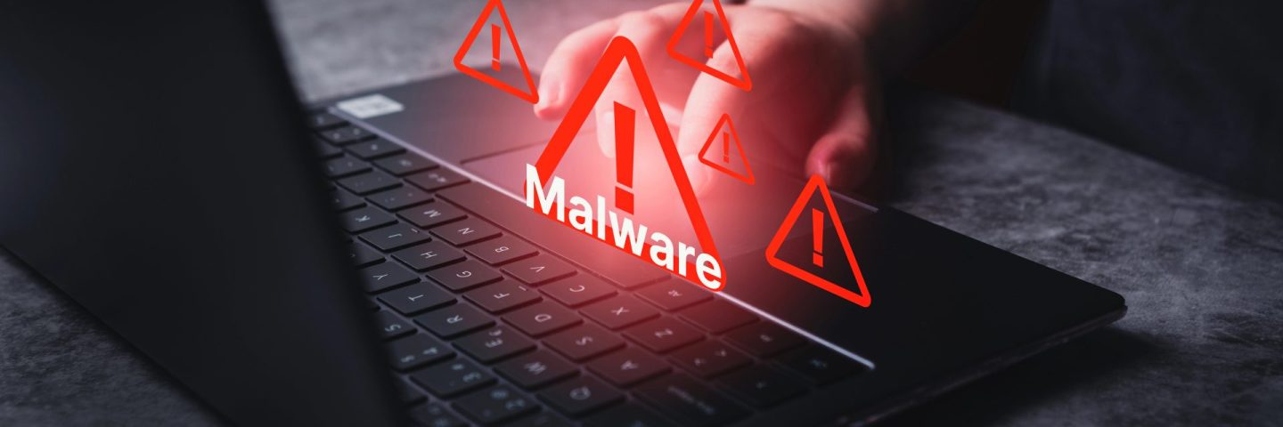 System hacked warning alert on laptop. Virus, Spyware, Malware or Malicious software. Woman receives warning notification on laptop.