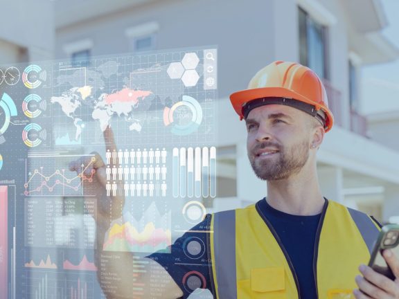 Engineer builder worker using advance technology digital hologram infographics touch panel in housing construction industry.