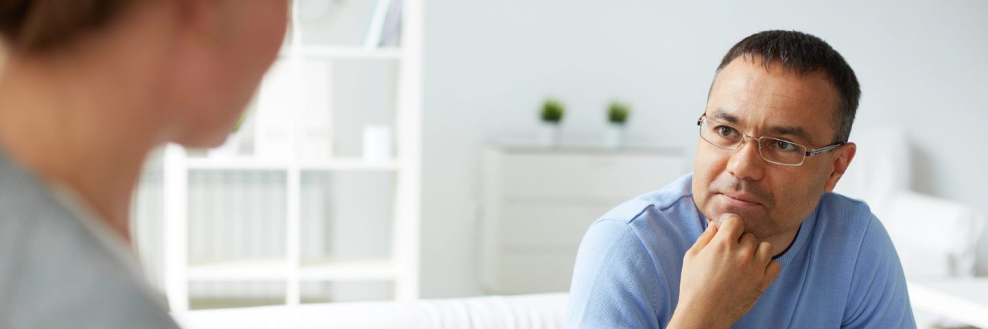 man in eyeglasses listening to psychologist