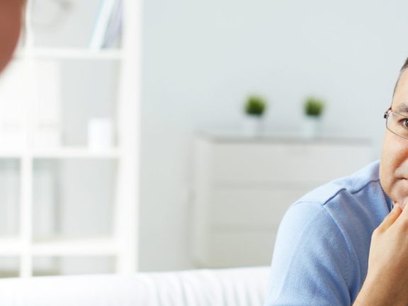 man in eyeglasses listening to psychologist