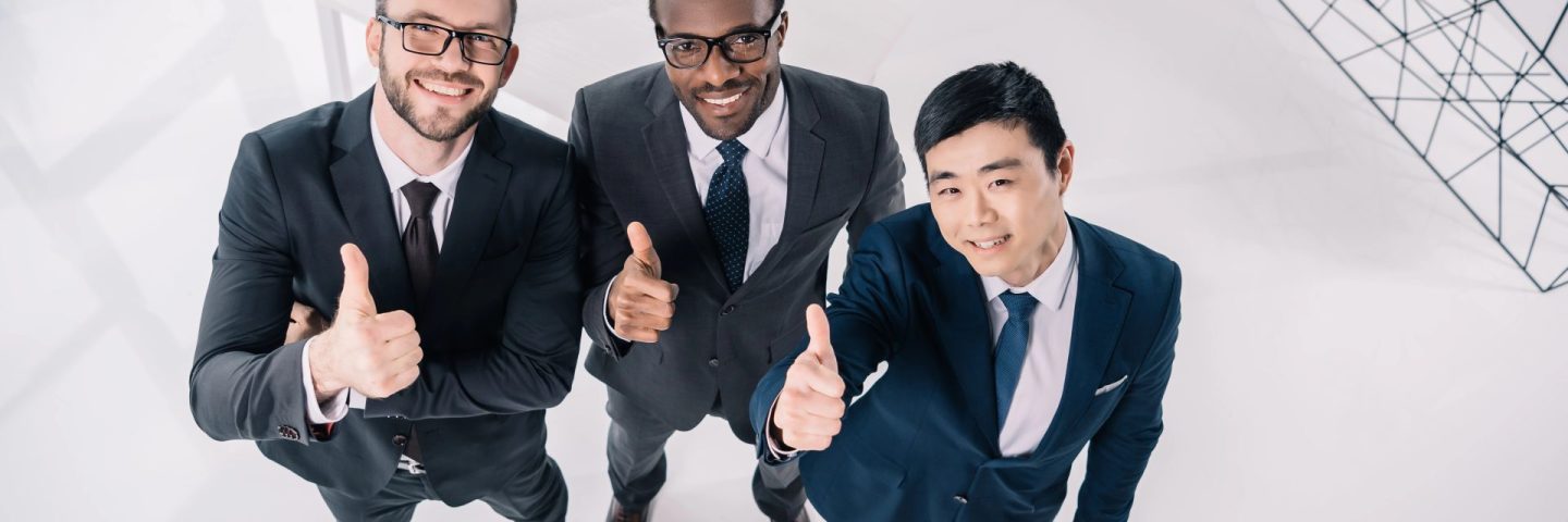 businessmen showing thumbs up