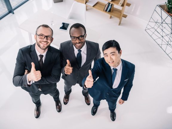 businessmen showing thumbs up