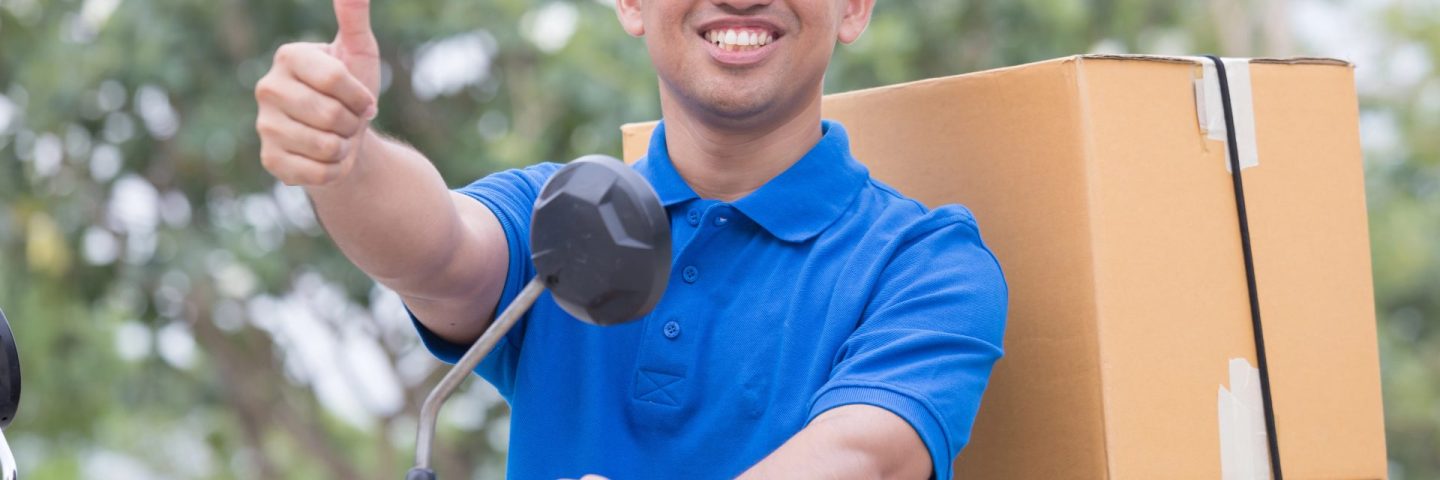 Delivery man send order parcel with motors and thumb up