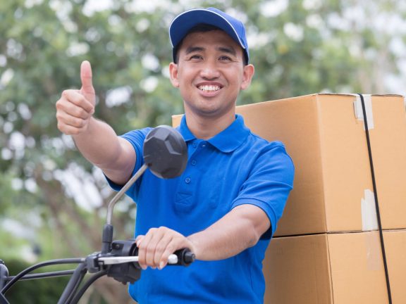 Delivery man send order parcel with motors and thumb up