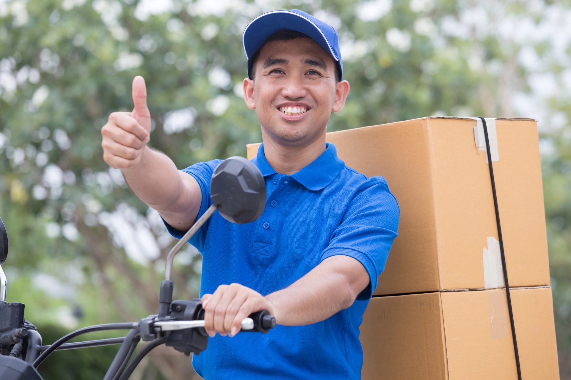 Delivery man send order parcel with motors and thumb up