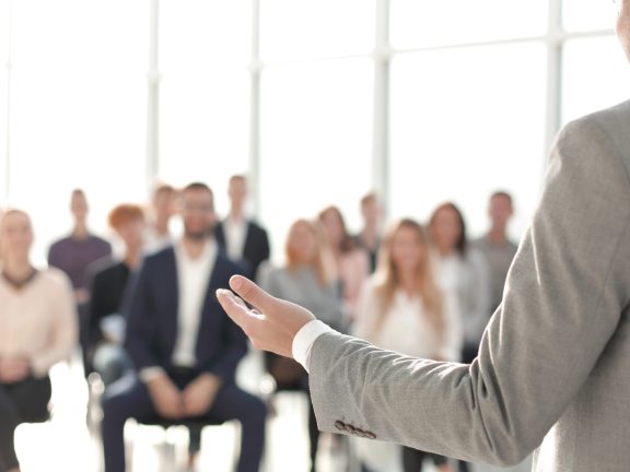 image of a speaker giving a lecture at a business seminar