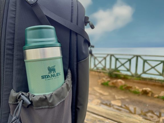 Antalya, Turkey - February 9, 2024: Stanley Action Trigger stands next to traveler's backpack