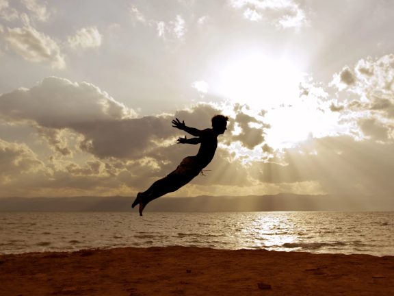 One person acrobatic jumping scene symbolize vitality, aspiration, success, progress