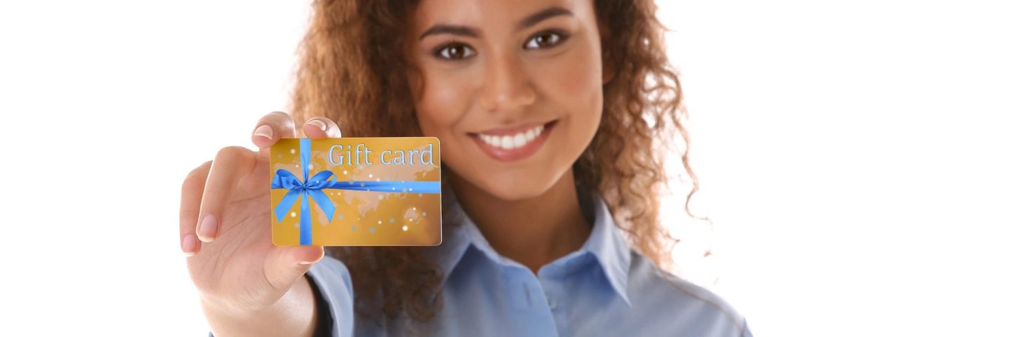 Young woman with gift card on white background. Holiday celebration concept.