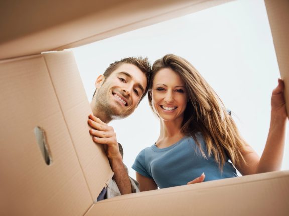 Happy couple opening a box