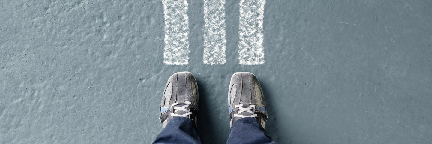 man standing with arrow choices