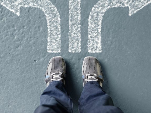 man standing with arrow choices