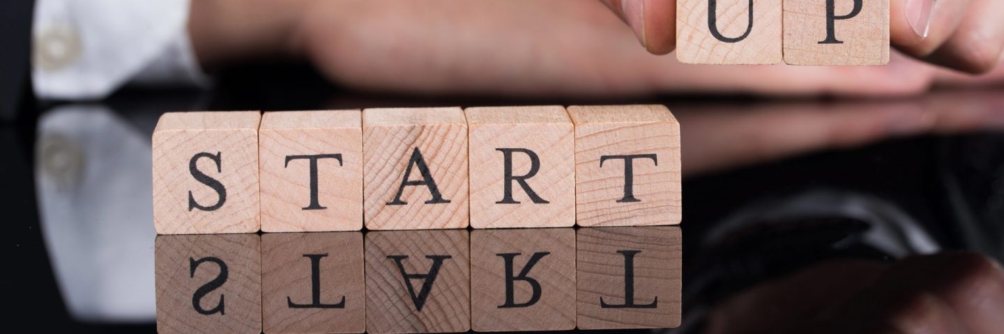 Businessman Arranging Startup Blocks On Desk