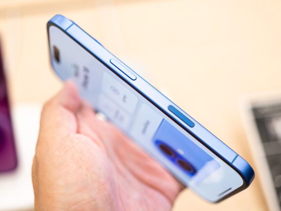 Bangkok Thailand SEP 20 2024: Apple launch new smartphone iPhone 16 displayed in a Store. Hand holding iPhone 16 Ultramarine and showing the new Camera Control button.