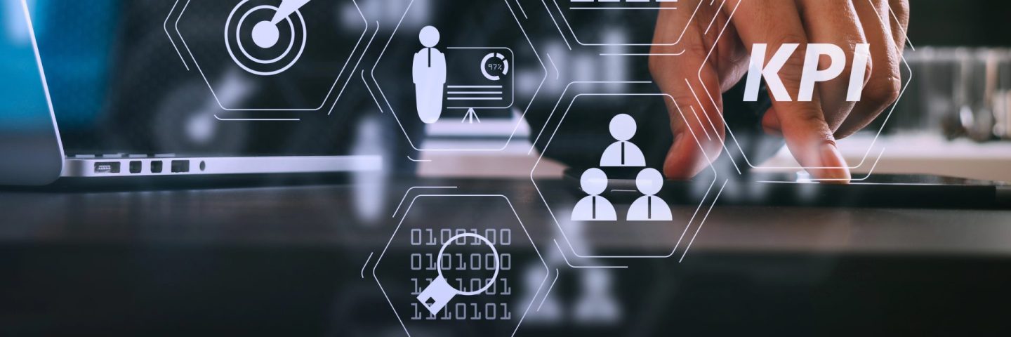 Key Performance Indicator (KPI) workinng with Business Intelligence (BI) metrics to measure achievement and planned target.businessman using digital tablet and laptop computer and document in modern office