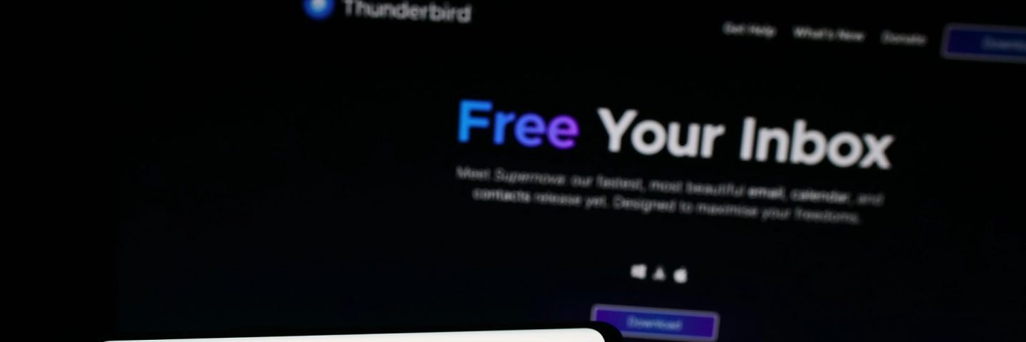 Stuttgart, Germany - 10-25-2023: Person holding mobile phone with logo of open-source e-mail client Mozilla Thunderbird in front of web page. Focus on phone display.