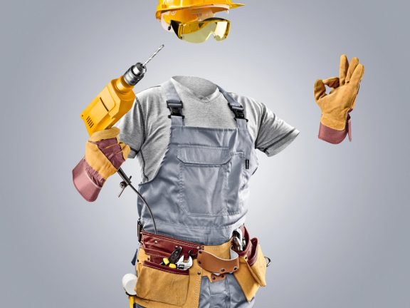 invisible worker in helmet with drill