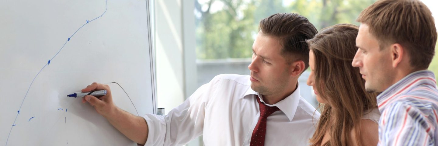 Leader explaining something on whiteboard