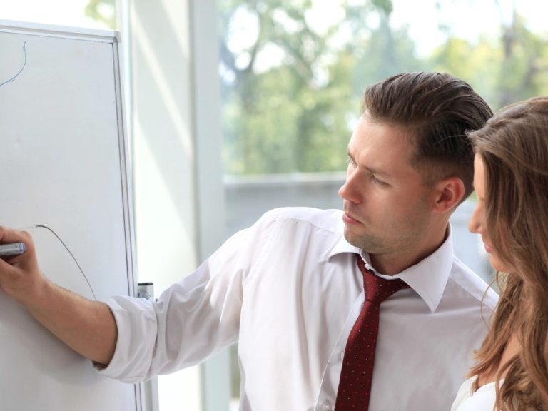 Leader explaining something on whiteboard