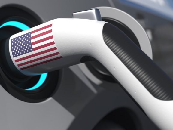 Flag of the USA on the charging plug in an electric car. Conceptual 3d rendering