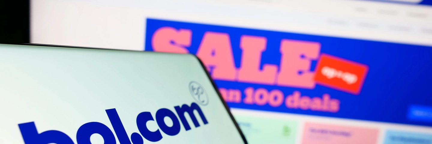 Stuttgart, Germany - 07-11-2023: Cellphone with logo of Dutch e-commerce company bol.com B.V. on screen in front of business website. Focus on center-left of phone display.