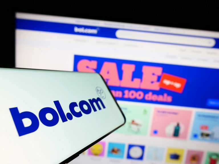 Stuttgart, Germany - 07-11-2023: Cellphone with logo of Dutch e-commerce company bol.com B.V. on screen in front of business website. Focus on center-left of phone display.