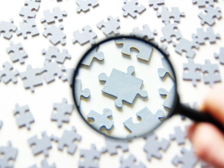 Magnifying glass and puzzle