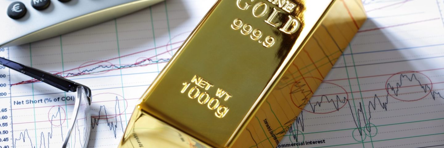 Gold bullion barr on a stocks and shares chart